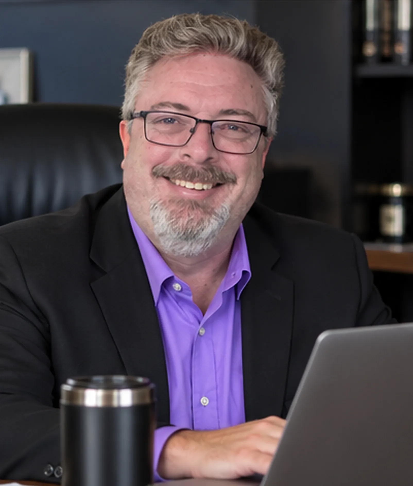 Corey Frasure at a desk with a laptop