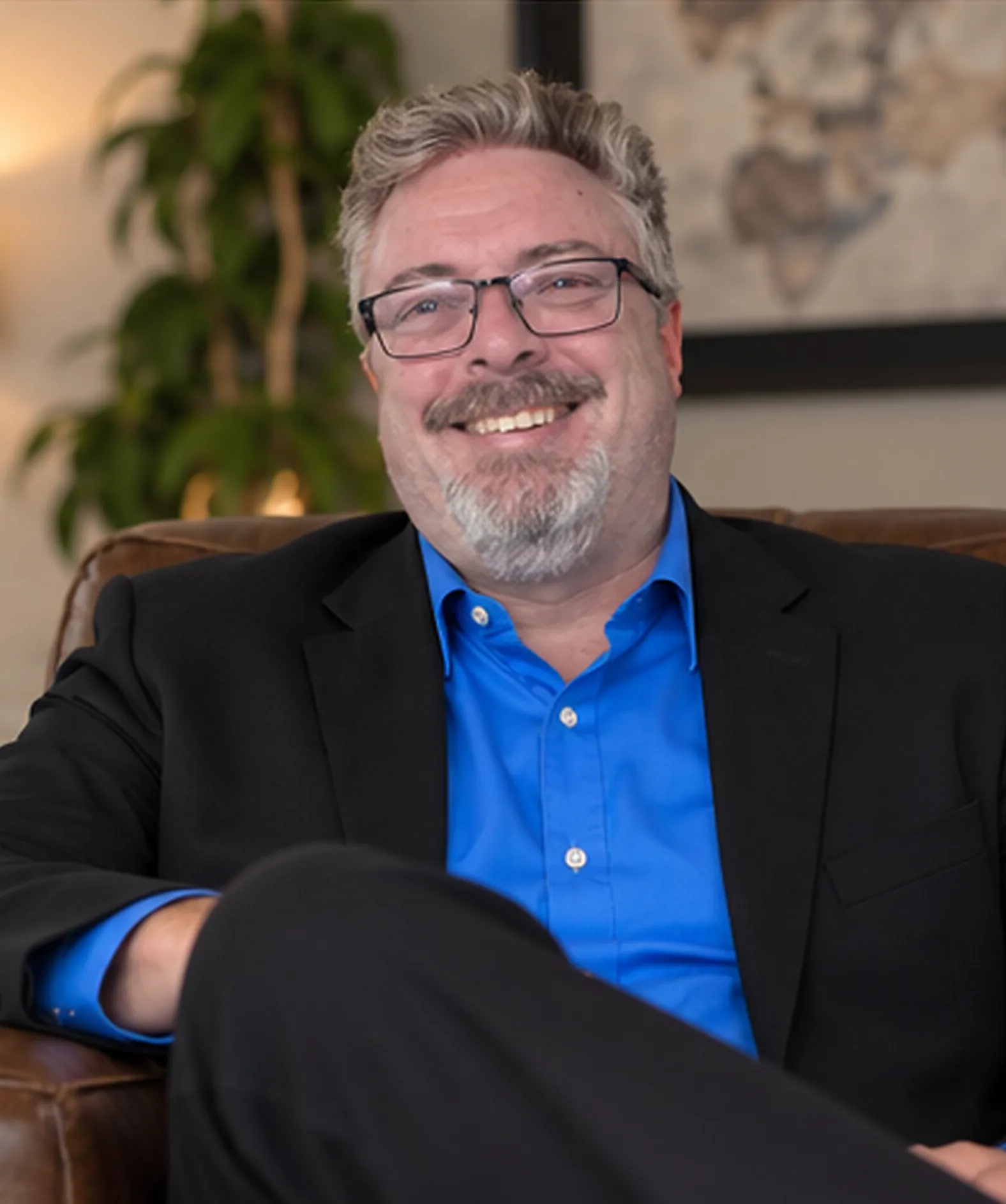 Corey Frasure seated in a leather chair